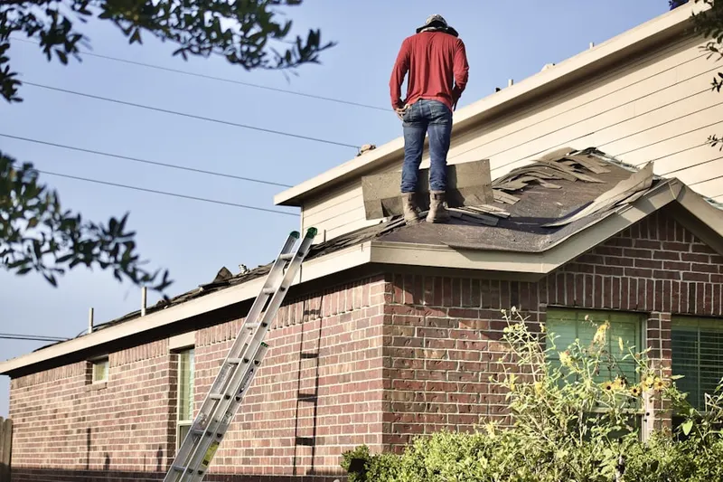 Professional roofer working on a residential roof in Muscoy